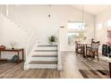 Bright foyer with staircase, hardwood floors, and open dining area offering a welcoming and spacious entry at 15852 S 18Th Ln, Phoenix, AZ 85045
