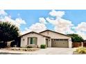 Charming single-story home with a well-manicured lawn and attached two-car garage at 2487 E Aris Dr, Gilbert, AZ 85298