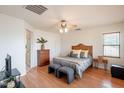 Cozy bedroom with a ceiling fan, hardwood floors, and ample natural light, creating a relaxing atmosphere at 2873 S Arroyo Ln, Gilbert, AZ 85295
