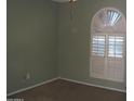 Bedroom featuring neutral carpet and unique window shutters at 4718 W El Caminito Dr, Glendale, AZ 85302