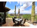Outdoor patio features tile flooring, patio furniture, and views of the surrounding desert landscape at 6114 E Carriage Dr, Cave Creek, AZ 85331