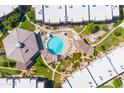 Aerial view of community pool area with lounge chairs, shaded seating, and beautifully landscaped grounds at 7436 E Chaparral Rd # 159B, Scottsdale, AZ 85250