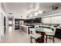 Spacious kitchen featuring dark cabinetry, stainless appliances, and an island at 951 N Norfolk St, Mesa, AZ 85205