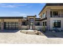 Modern home featuring stone accents, a paved driveway and meticulous desert landscaping at 9711 N Palisades Blvd, Fountain Hills, AZ 85268