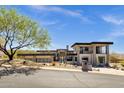 Modern home with desert landscaping, architectural details and a three car garage at 9711 N Palisades Blvd, Fountain Hills, AZ 85268