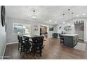 Open dining area with sleek black table and chairs, flowing into the kitchen space at 10010 N 64Th Ave, Glendale, AZ 85302