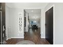 Inviting entryway featuring wood-look floors and a decorative 'Home' sign at 10010 N 64Th Ave, Glendale, AZ 85302