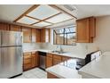 Bright kitchen with stainless steel appliances, white countertops, and a garden window at 10235 N 31St St # 17, Phoenix, AZ 85028