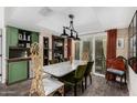 Elegant dining room features a marble table, green velvet chairs, and stylish decor at 1025 E Northern Ave, Phoenix, AZ 85020