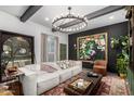 Stylish living room boasts modern decor, a cozy sofa and a unique chandelier at 1025 E Northern Ave, Phoenix, AZ 85020