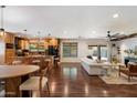 Expansive open living area featuring hardwood flooring, natural light, and a seamless transition to the kitchen at 10896 N 105Th Way, Scottsdale, AZ 85259