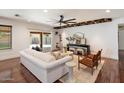 Bright living room with a comfortable sofa, stylish decor, and sliding doors to a beautifully landscaped backyard at 10896 N 105Th Way, Scottsdale, AZ 85259