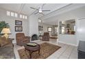 Cozy living room with fireplace, tile flooring, and access to the kitchen and dining area at 1216 E Ormondo Way, Phoenix, AZ 85014