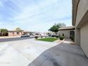 Spacious home featuring an extra-long driveway, desert landscaping, and a well-maintained lawn at 14703 W Hillside St, Goodyear, AZ 85395