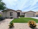 Inviting single-Gathering home with manicured lawn, desert plants, and a well-maintained front yard and charming curb appeal at 14703 W Hillside St, Goodyear, AZ 85395