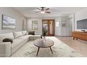 Bright living room featuring neutral walls, stylish furniture, and glass doors leading to the outdoor patio at 16229 W Jenan Dr, Surprise, AZ 85379
