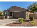 Stylish one-story home with a desert front yard, showcasing its tidy facade and attached two-car garage at 17971 W Meadowbrook Ave, Goodyear, AZ 85395