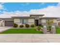 Beautiful single-story home with manicured front lawn and neutral stucco facade at 18134 W Highland Ave, Goodyear, AZ 85395