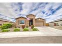 Attractive single-Gathering home with stone accents, a two-car garage, and manicured landscaping at 19742 W Harrison St, Buckeye, AZ 85326