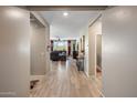 Hallway view into the living room with seamless flooring from end to end at 20181 N Lauren Rd, Maricopa, AZ 85138