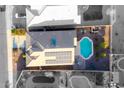 Aerial view of a home's roof showing solar panels and backyard pool, surrounded by neighboring properties at 21963 W Tonto St, Buckeye, AZ 85326
