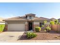 Charming single-story home featuring a tile roof, stone accents, desert landscaping, and a two-car garage at 21963 W Tonto St, Buckeye, AZ 85326