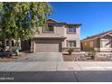 Two-story home with a well-manicured lawn and a two-car garage at 22741 N Scott Dr, Maricopa, AZ 85138