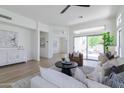 Spacious living room with a comfortable seating arrangement, neutral tones, and sliding doors to a patio at 23046 N 88Th Way, Scottsdale, AZ 85255
