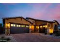 Beautiful stucco home with stone accents, large driveway, and three-car garage at 2361 N 156Th Dr, Goodyear, AZ 85395