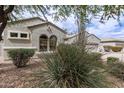 Inviting home featuring arched windows and desert landscaping for a unique curb appeal at 2600 E Hazeltine Way, Chandler, AZ 85249