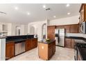 Well-equipped kitchen showcasing stainless steel appliances, a central island, and granite countertops at 2600 E Hazeltine Way, Chandler, AZ 85249