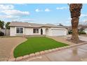 Inviting single-story home with a well-manicured front yard and a two-car garage at 3026 E Bremen St, Phoenix, AZ 85032