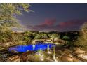 Beautiful desert home with pool, spa and mountain views at dusk at 30330 N 77Th Pl, Scottsdale, AZ 85266