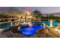 Desert home's pool boasts a spa, stacked stone and mature landscaping at 30330 N 77Th Pl, Scottsdale, AZ 85266