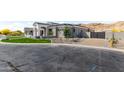 A sprawling single-story home with xeriscaping, a modern design and a gated entrance at 3046 W Redwood Ln, Phoenix, AZ 85045