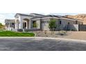 A well-manicured single-story home with neutral color scheme, xeriscaping, and three-car garage at 3046 W Redwood Ln, Phoenix, AZ 85045