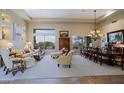 Bright living room featuring high ceilings, large windows, and elegant decor at 33242 N 68Th Pl, Scottsdale, AZ 85266