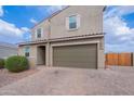 Attractive two-story house showcasing desert landscaping, a brick-paved driveway, and neutral tones at 37185 N Falabella Dr, San Tan Valley, AZ 85140