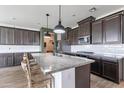 Modern kitchen with stainless steel appliances, granite countertops, an island, and ample cabinet space at 37185 N Falabella Dr, San Tan Valley, AZ 85140