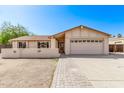 Charming single-story home with a neutral color palette, two car garage, and paved walkway at 3941 W Desert Hills Dr, Phoenix, AZ 85029