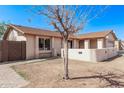 Home exterior featuring a neutral stucco, brick walkway, and mature tree in front yard at 3941 W Desert Hills Dr, Phoenix, AZ 85029