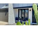 Charming home featuring a brick wall accent, black trim windows, and a well-kept front porch at 4038 W Windrose Dr, Phoenix, AZ 85029
