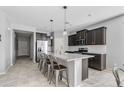 Open-concept kitchen boasts a large island, stainless steel appliances, and sleek gray cabinets at 4087 W Coneflower Ln, San Tan Valley, AZ 85144