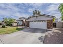 Attached two-car garage and driveway of a single-Gathering home with well maintained front yard at 4215 S Marisol Ln, Gilbert, AZ 85297