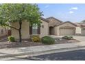 Well-maintained one-story house enhanced by verdant landscaping and a paved driveway to the attached three-car garage at 4497 E Ficus Way, Gilbert, AZ 85298