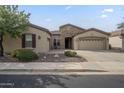Attractive single-level home showcasing a well-kept front yard and a driveway leading to a convenient three-car garage at 4497 E Ficus Way, Gilbert, AZ 85298