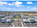 Aerial view of a modern community with well-planned streets, landscaping, mountain views, and consistent home design at 4615 S 23Rd Way, Phoenix, AZ 85040