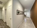 Hallway features tile flooring, fresh paint, and decorative picture frames at 4774 E Chromium Rd, San Tan Valley, AZ 85143