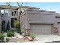 Inviting home with a two-car garage, desert landscaping, and a mix of stone and stucco exterior at 5118 S Morning Sky Trl, Gold Canyon, AZ 85118