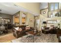 Spacious living room featuring hardwood floors, leather seating, and an open floor plan at 5118 S Morning Sky Trl, Gold Canyon, AZ 85118